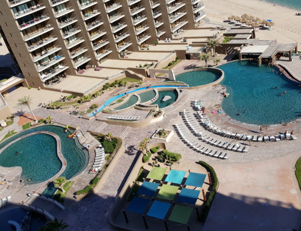 Great balcony views of the 4 diamond resort pools, swim-up bar and grille,  lazy river, hammock area and heated spa!