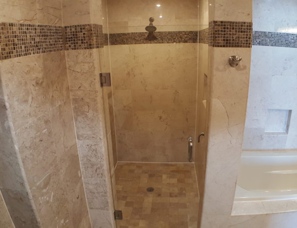 Large walk-in shower with glass door.